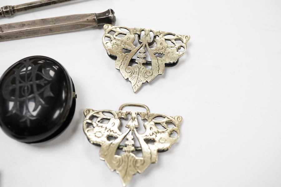 A group of jewellery, comprising: a locket, possibly in jet or bog oak, bearing the initials CIM, the interior with two compartments, length 4.6cm, design registration mark for circa 1861, maker's mark; three mechanical